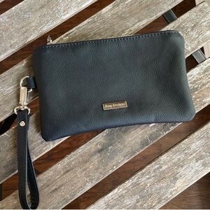 Wristlet in black leatherette. 360 swivel strap. Interior zipper pocket. NWOT.